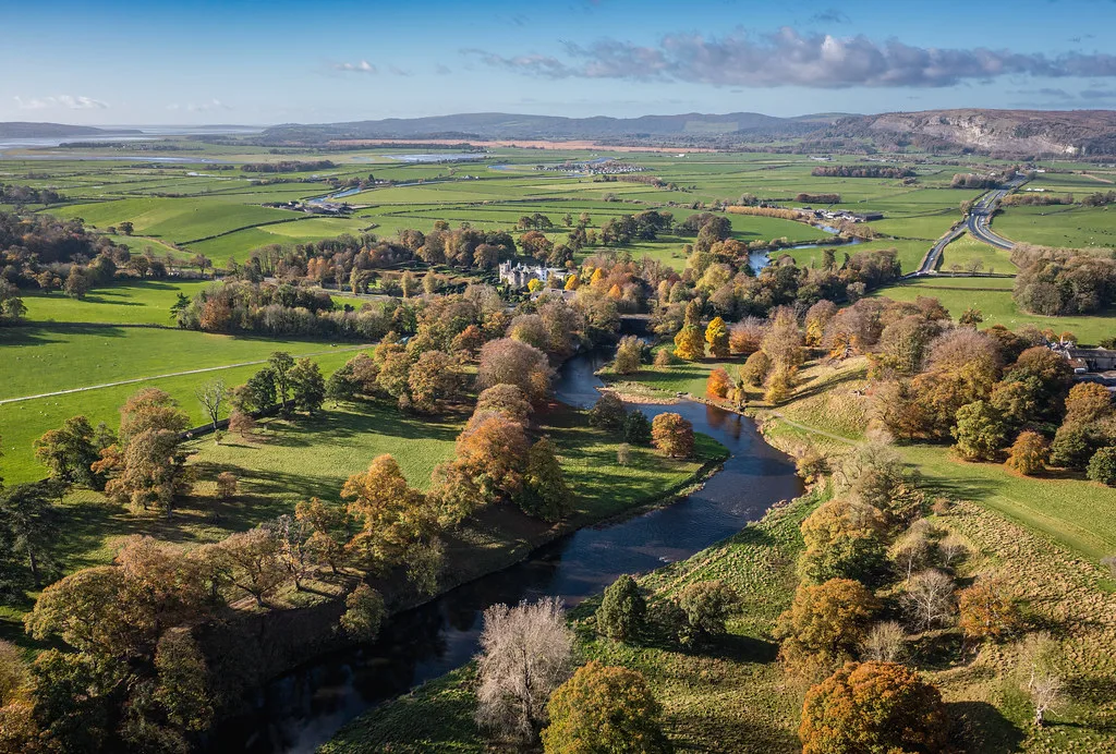 Levens Hall and the River Kent in autumn. The hall runs candle-lit Ghostly House Tours from 29 October to 1 November
