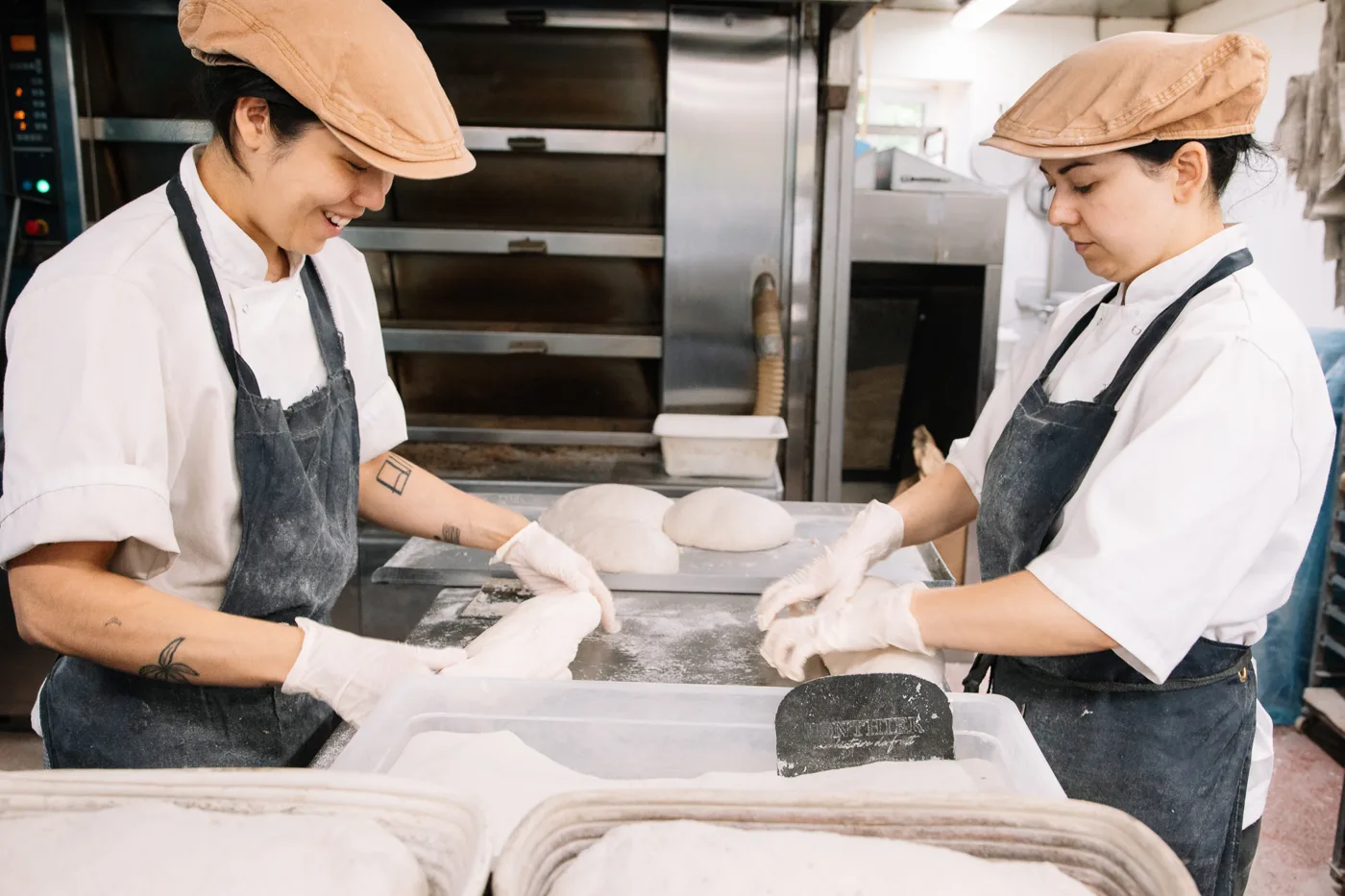 Members of the Lovingly Artisan bakery team shaping loaves